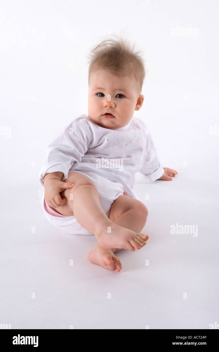 Woman supporting baby boy in upright sitting position - Stock Image -  C054/2147 - Science Photo Library