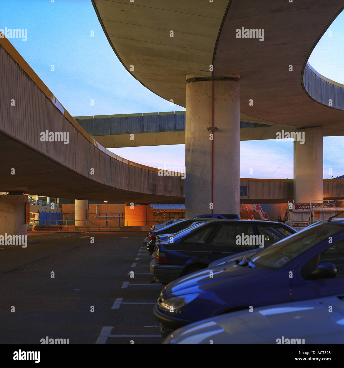 Dusk shot of car park exterior inc overhead ramp car wash vehicles