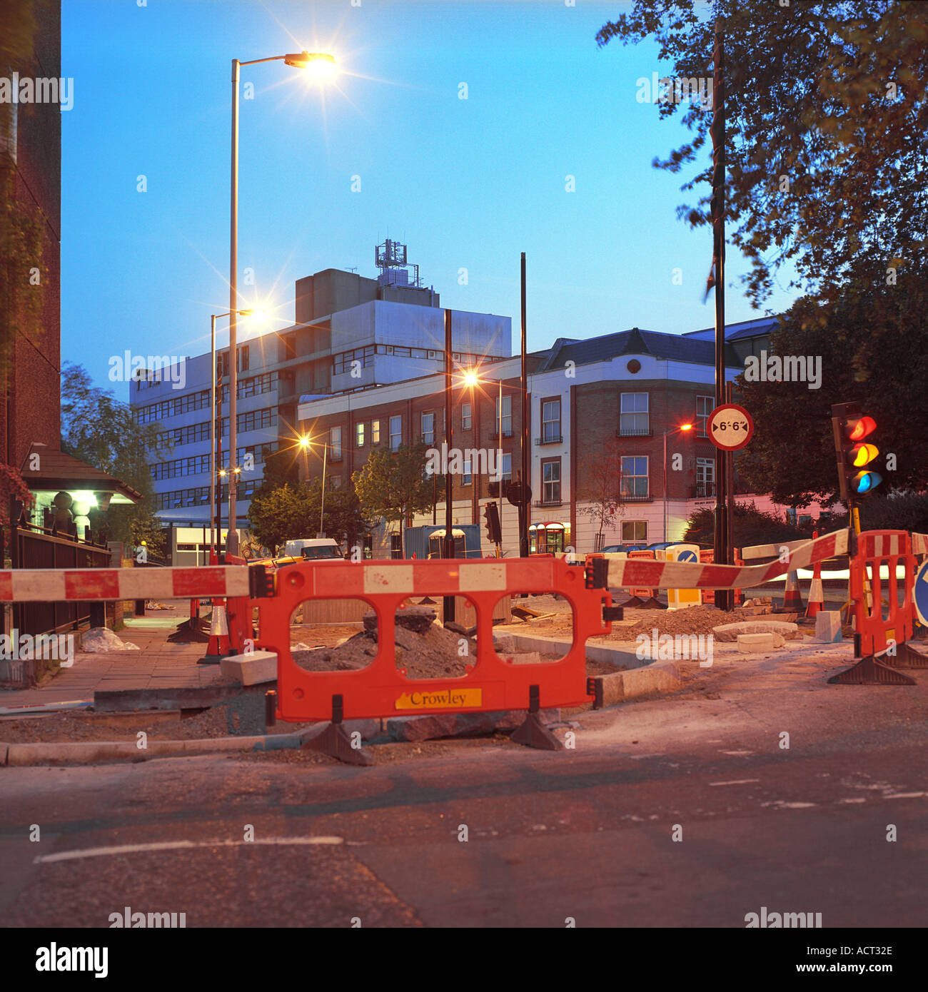 Dusk shot of roadworks London inc temporary traffic lights Stock Photo
