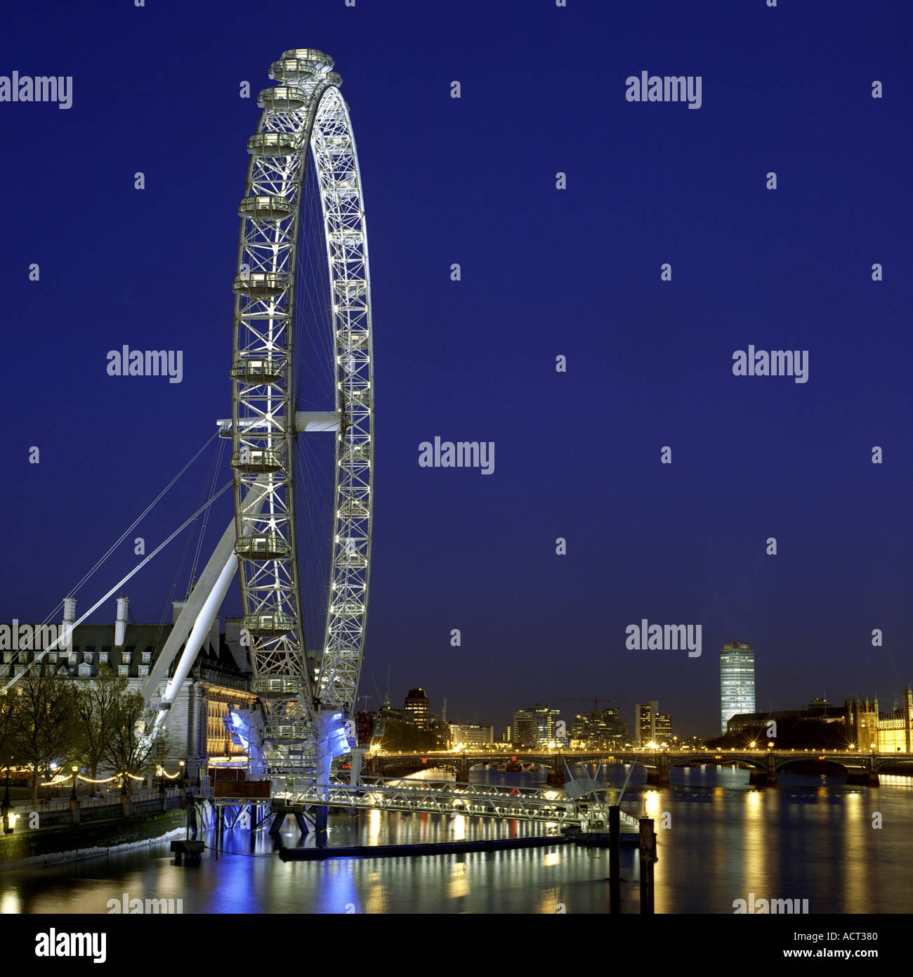 Night shot of BA London Eye Millennium Wheel Marks Barfield Architects deep blue sky over River Thames, London 2002 Stock Photo