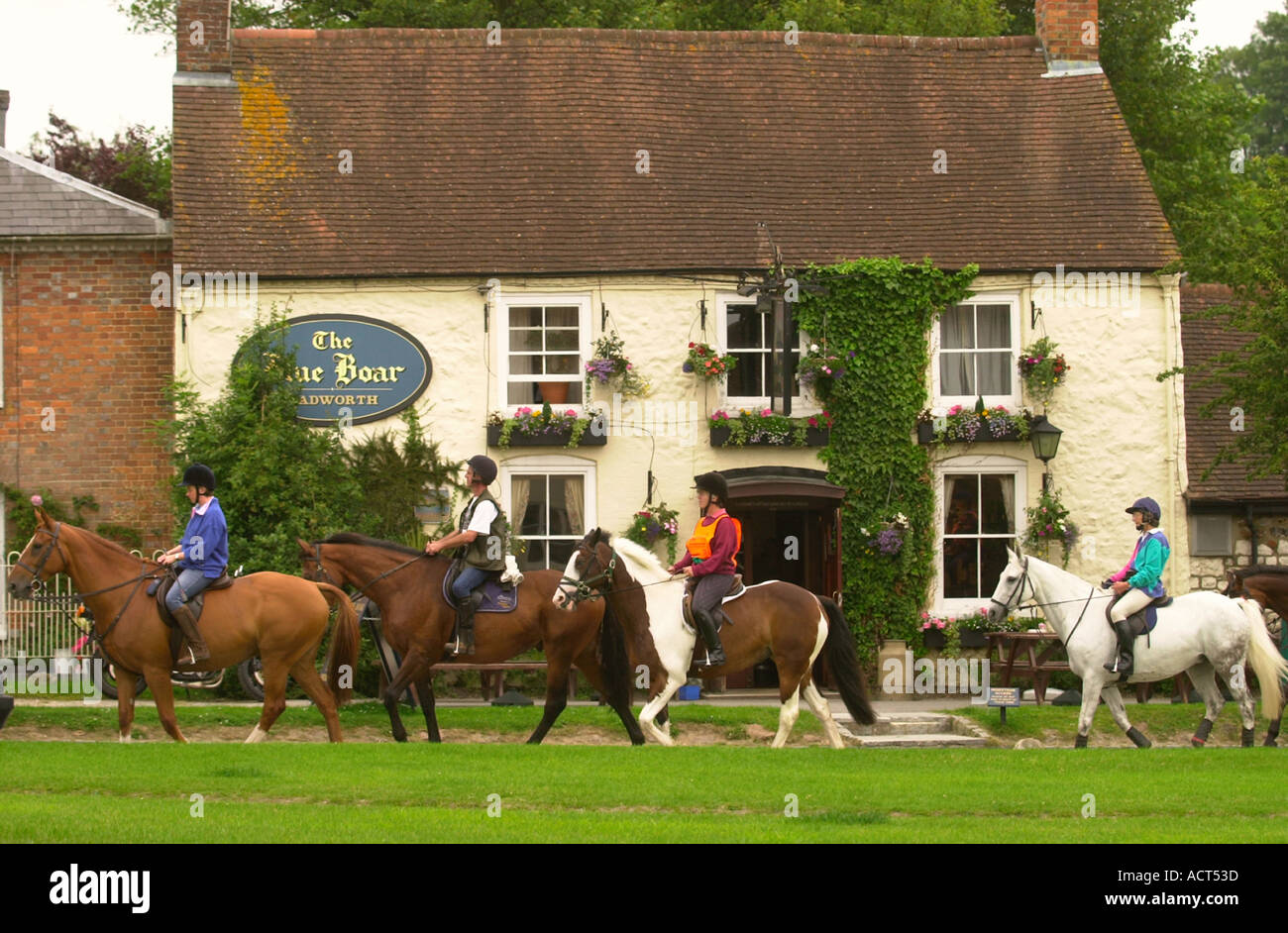 THE RIDGEWAY RIDE RIDERS PASS THE BLUE BOAR PUB IN THE VILLAGE OF ...