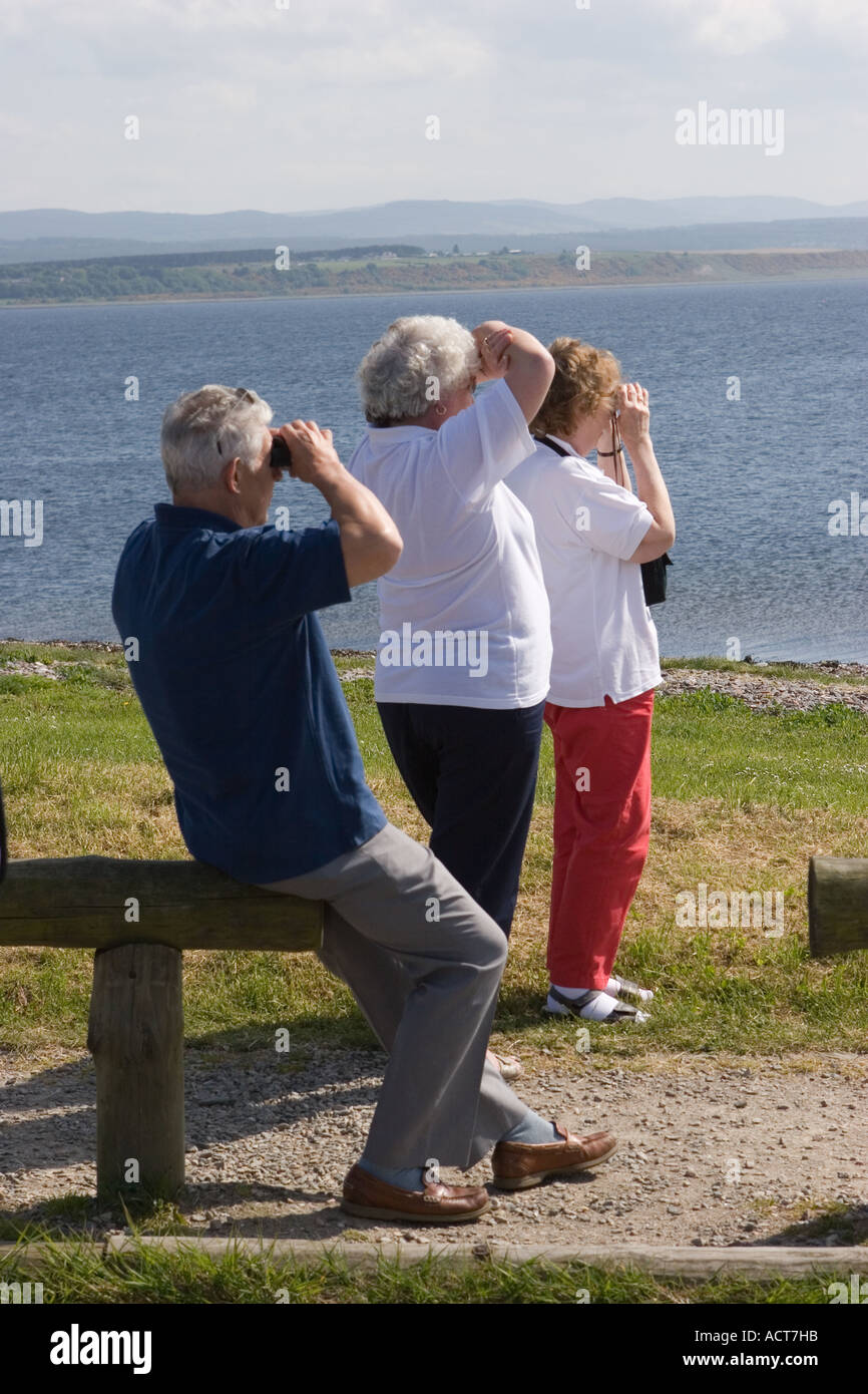 Dolphin watchers looking out to sea at Chanonry Point, Tourists watching the Moray Firth Bottlenose Dolphins, Cromarty, Black isle, Scotland, UK Stock Photo