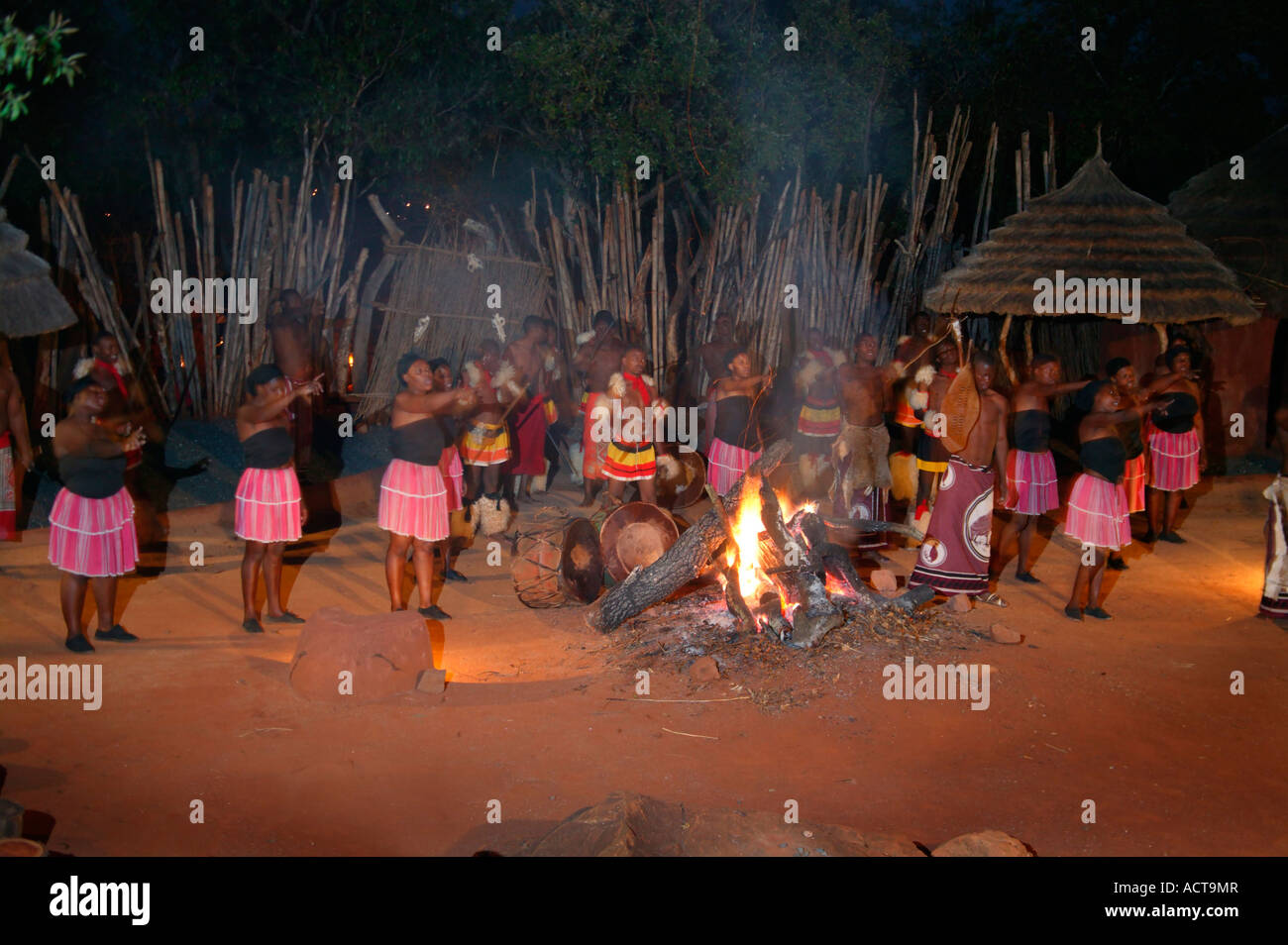 An evening dance show presented at the fireside in an outdoor boma at the Shangana cultural village Hazyview South Africa Stock Photo
