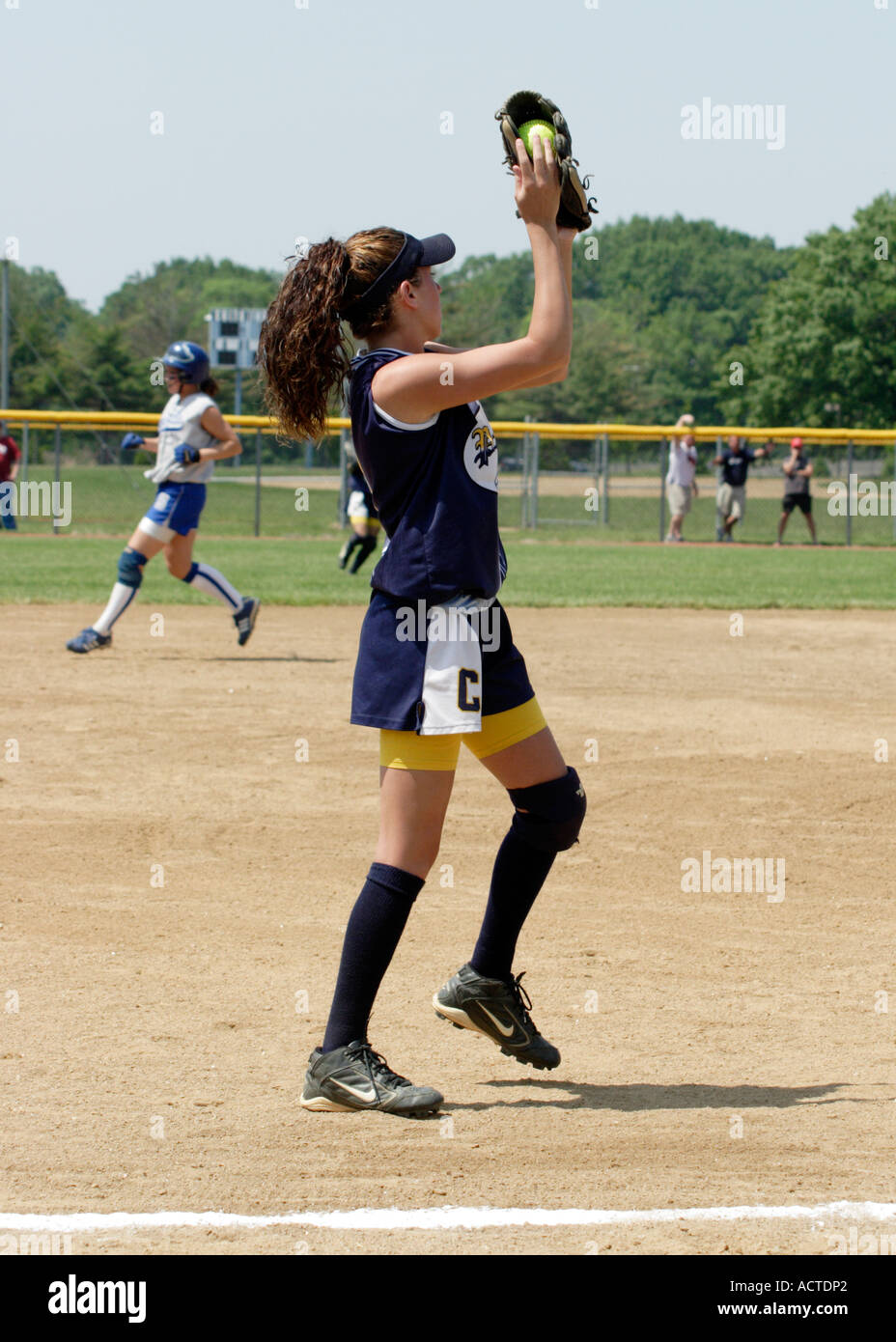 Softball third baseman catches a pop up Stock Photo Alamy