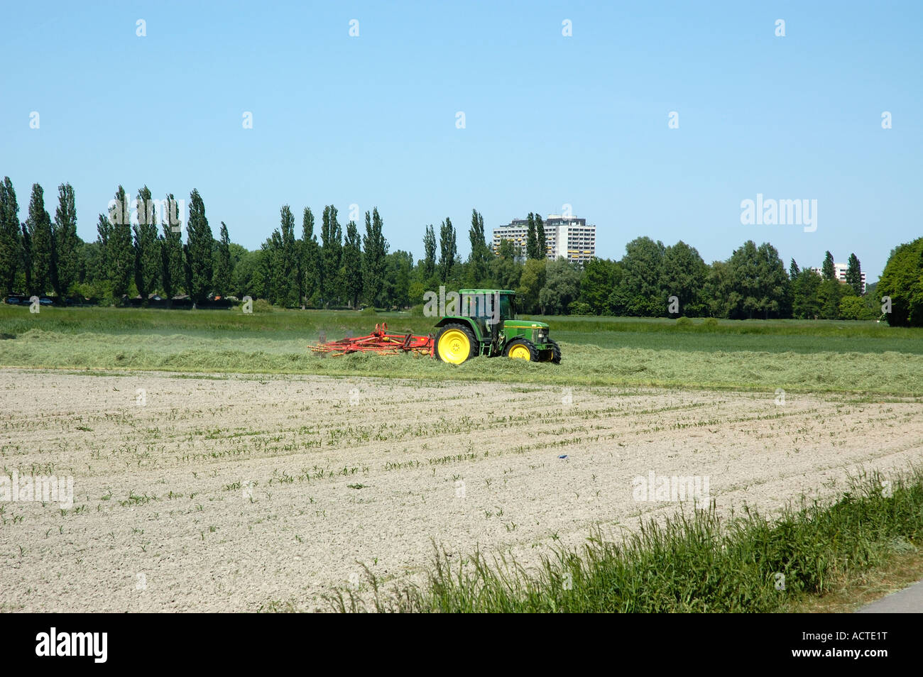 Tractor harvesting hay Stock Photo - Alamy