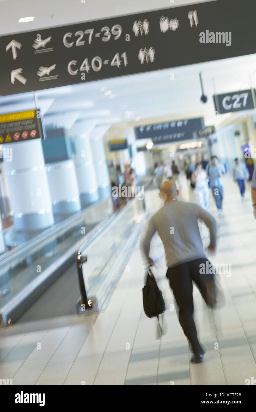 Passenger running to catch flight at airport Stock Photo Alamy