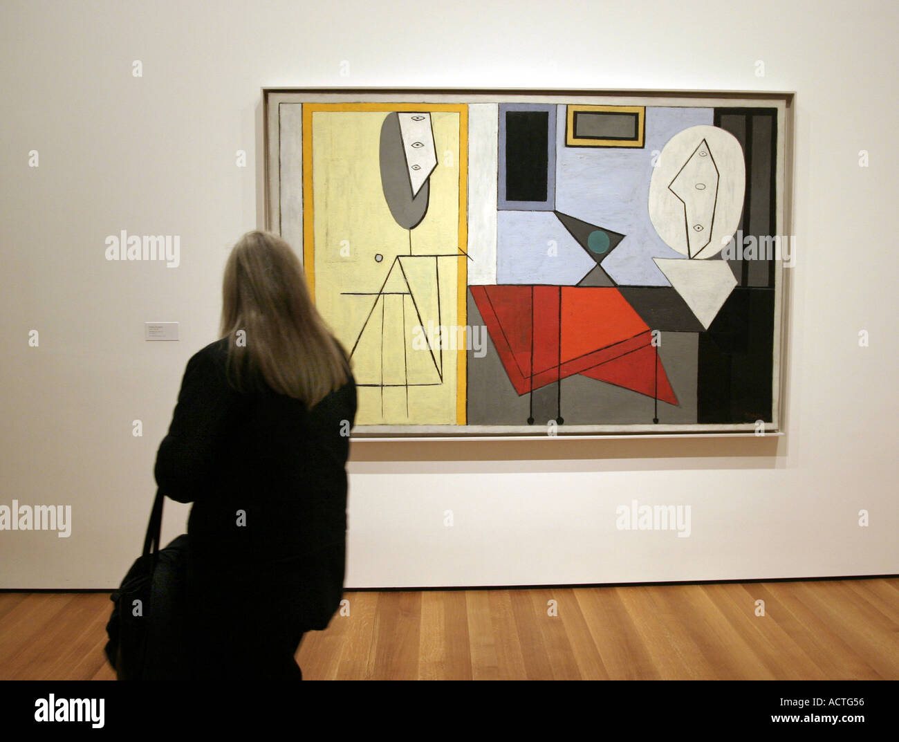 A visitor at the Museum of Modern Art New York looking at a Picasso Stock Photo