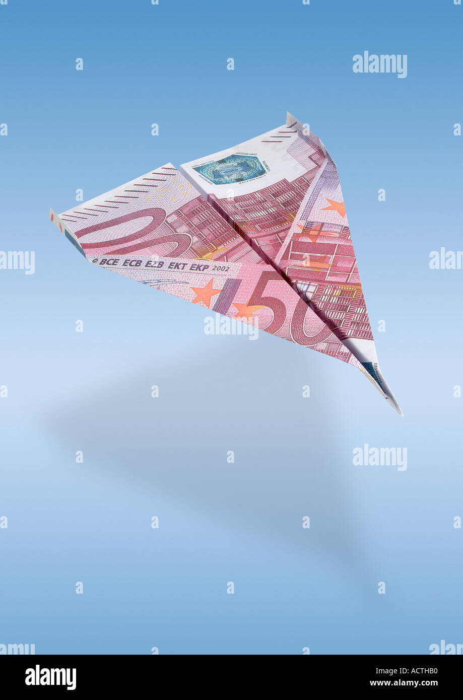 paperflier made from a euro bill Papierflugzeug aus Euroschein Stock Photo