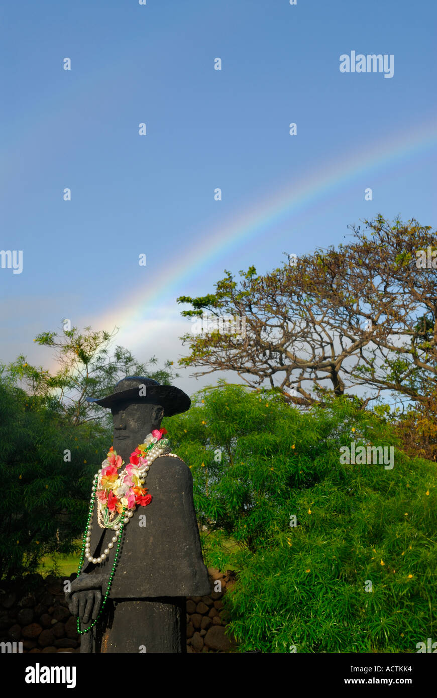 Rainbow over Statue of Father Damien leper missionary at St Joseph Church Molokai Hawaii Stock Photo