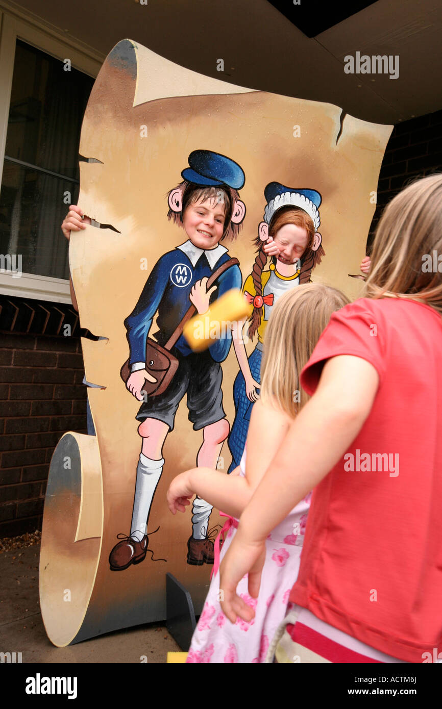 children at a local school fete throwing sponges at others Stock Photo