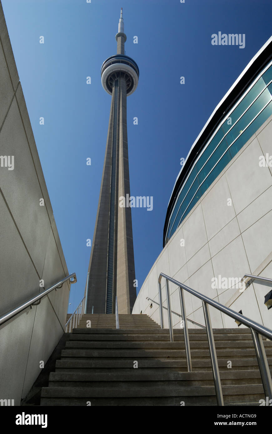 CN Tower over stairs between walls of Metro Toronto Convention Center Stock Photo