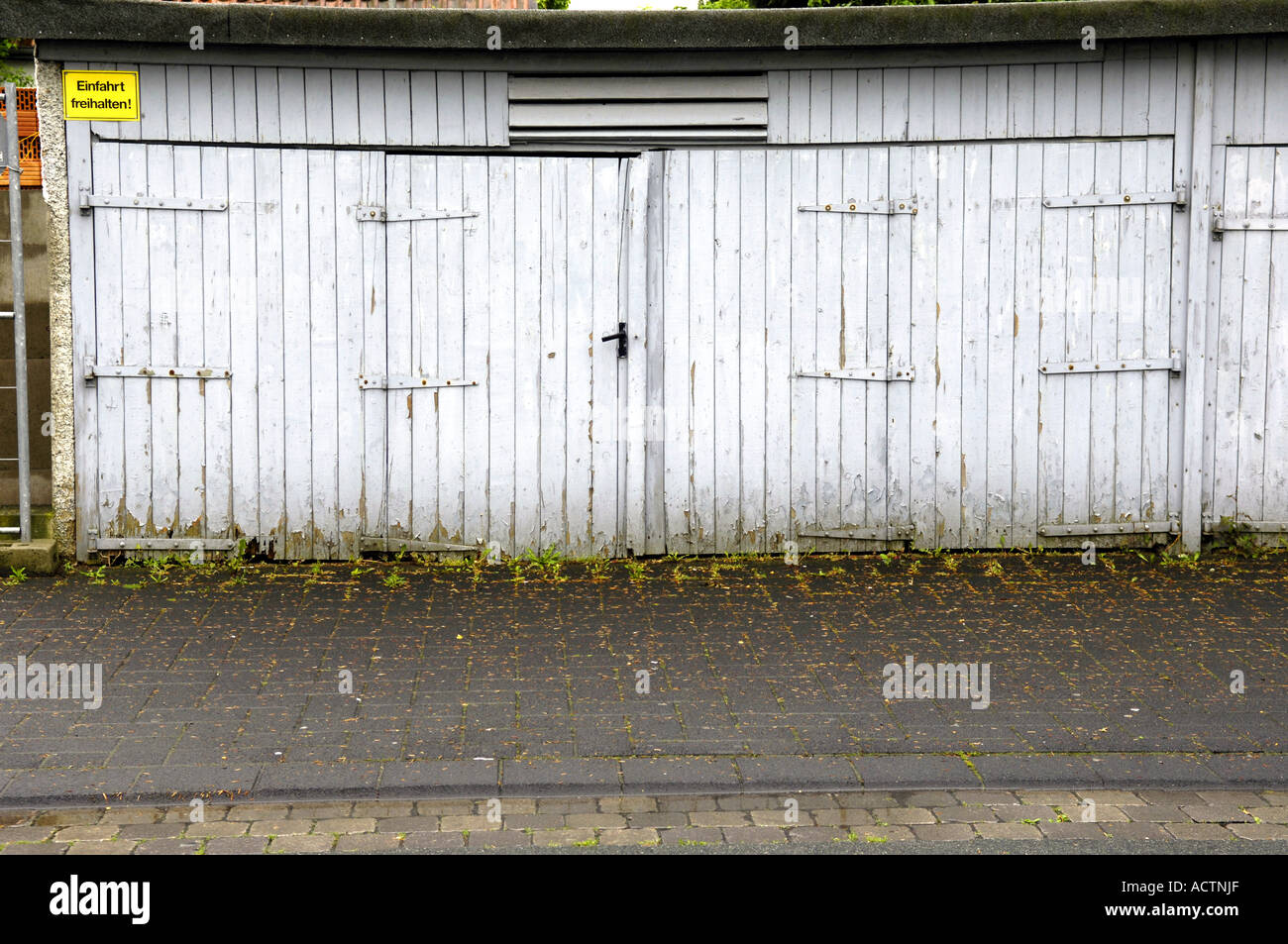 white lock up garages doors closed wood wooden normal boring plain