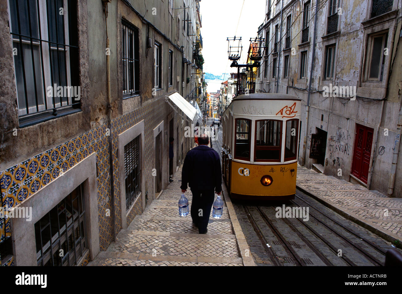 Lisbon Portugal Bairro Alto Tram Man Carrying Bottles Of Water Stock