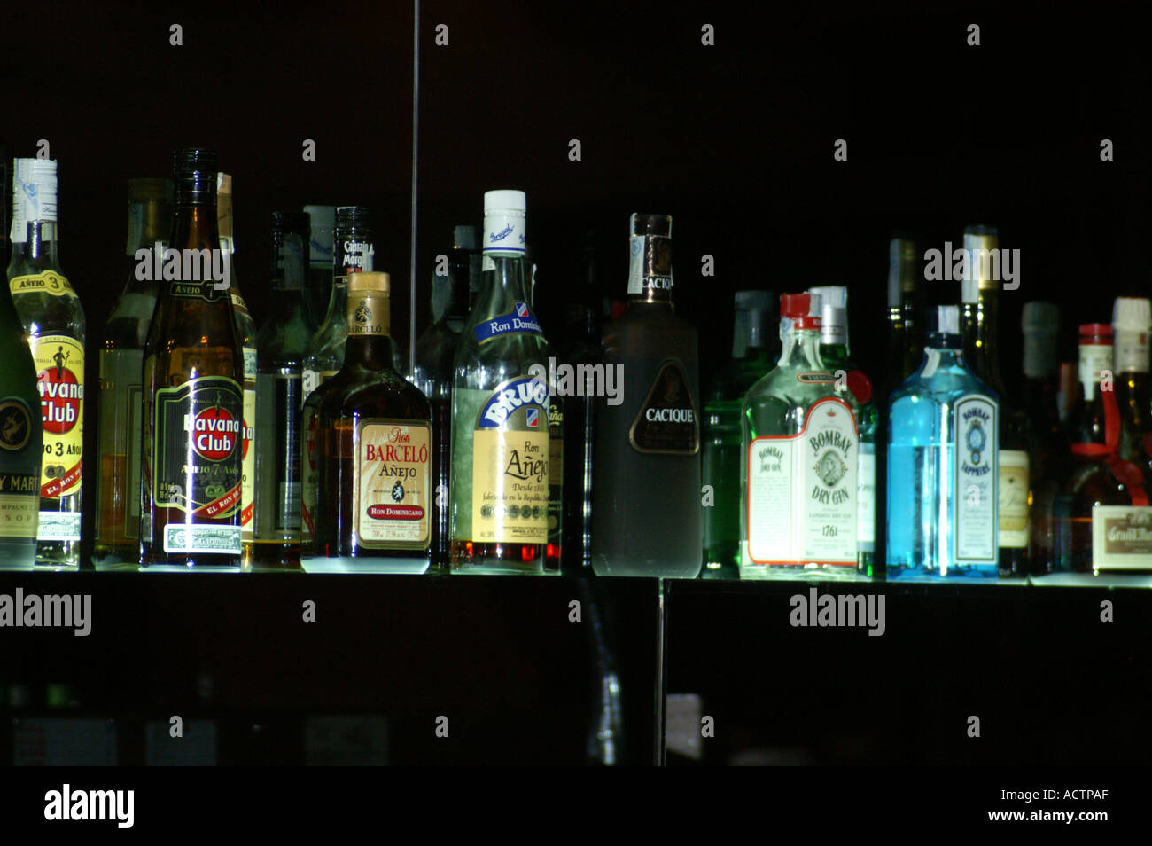 Bottles of spirits lit from below Stock Photo