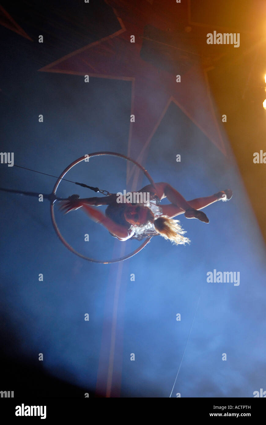 Circus acrobat performer using Aerial Hoop also known as "Cerceau" or "Lyra" a circular steel