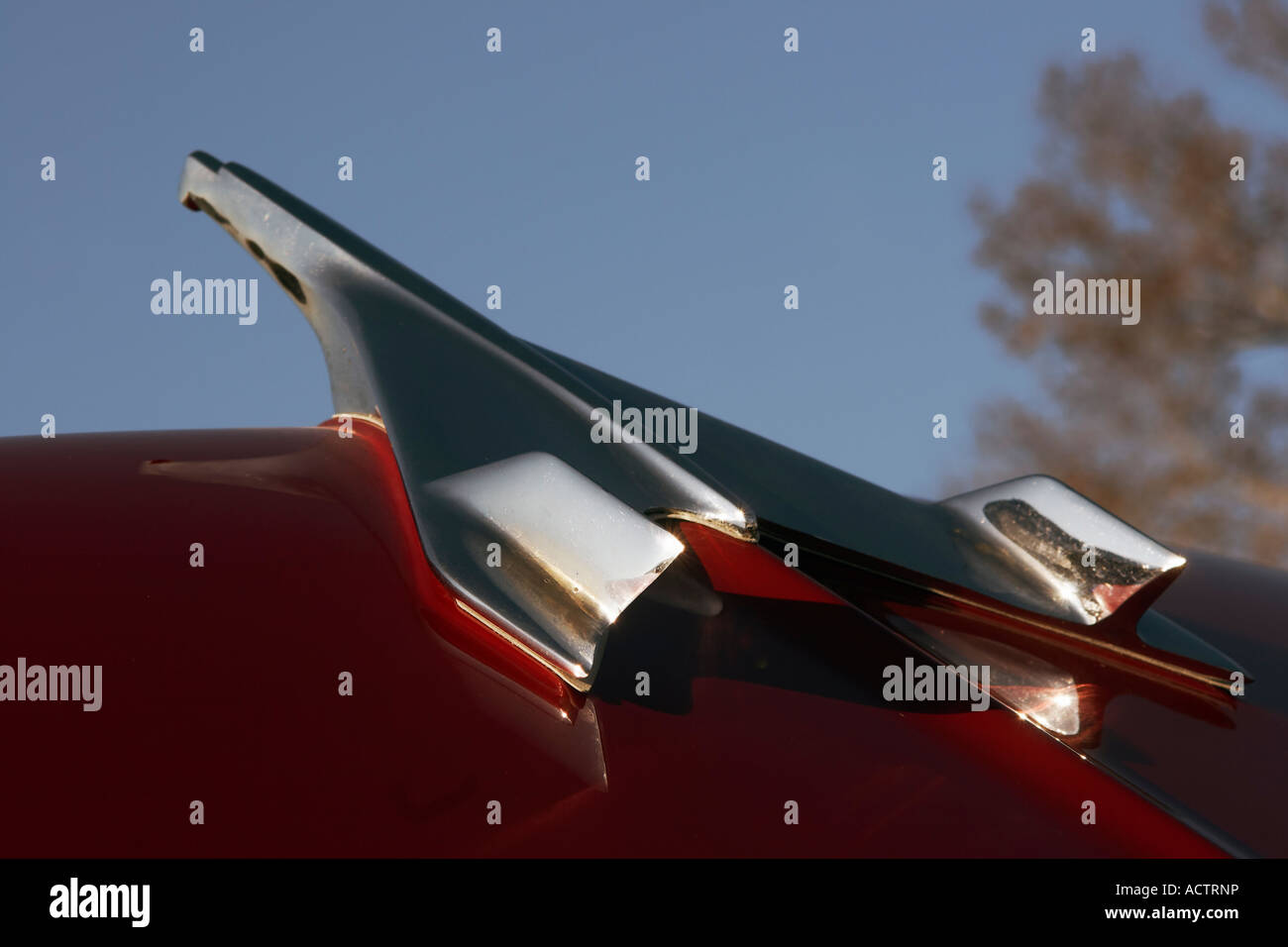 The hood ornament of a red 1956 Chevrolet Stock Photo