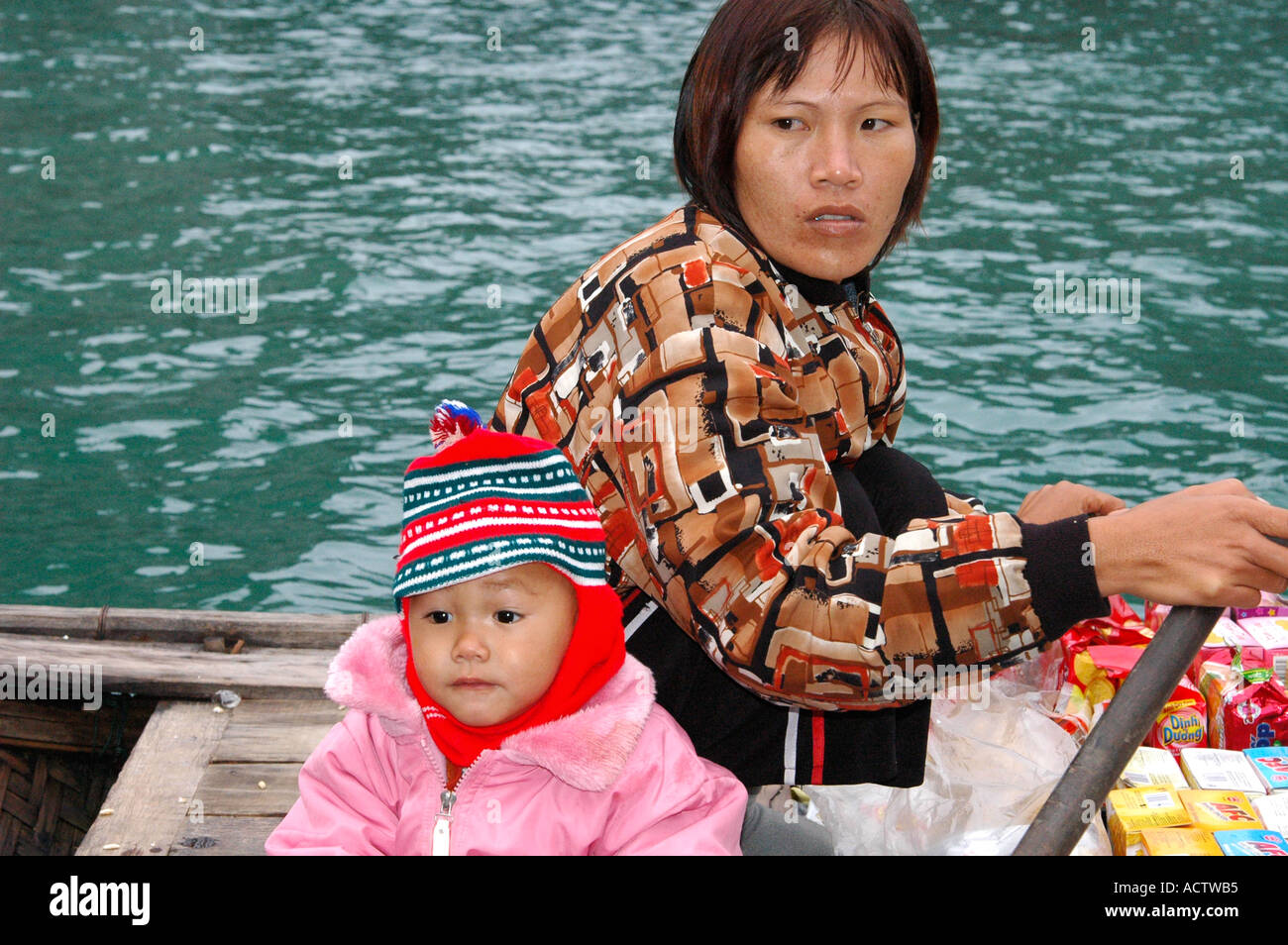 Female trader with child Vietnam Stock Photo