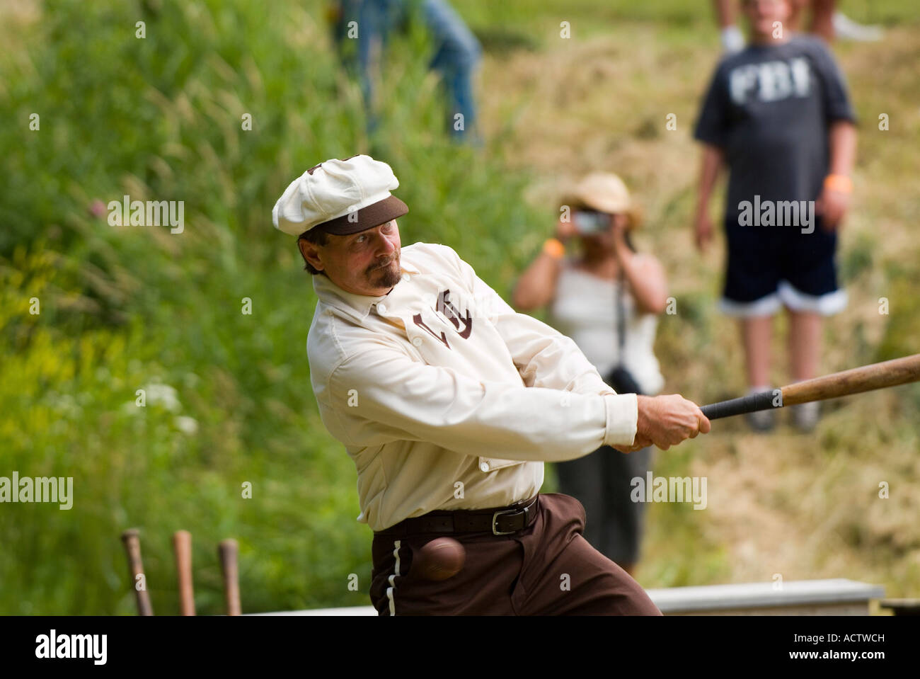 A BATSMAN IS TAKING A SWING AT THE BALL IN THE GAME PLAYED AT THE ENACTMENT OF WORLD WAR II ERA Stock Photo
