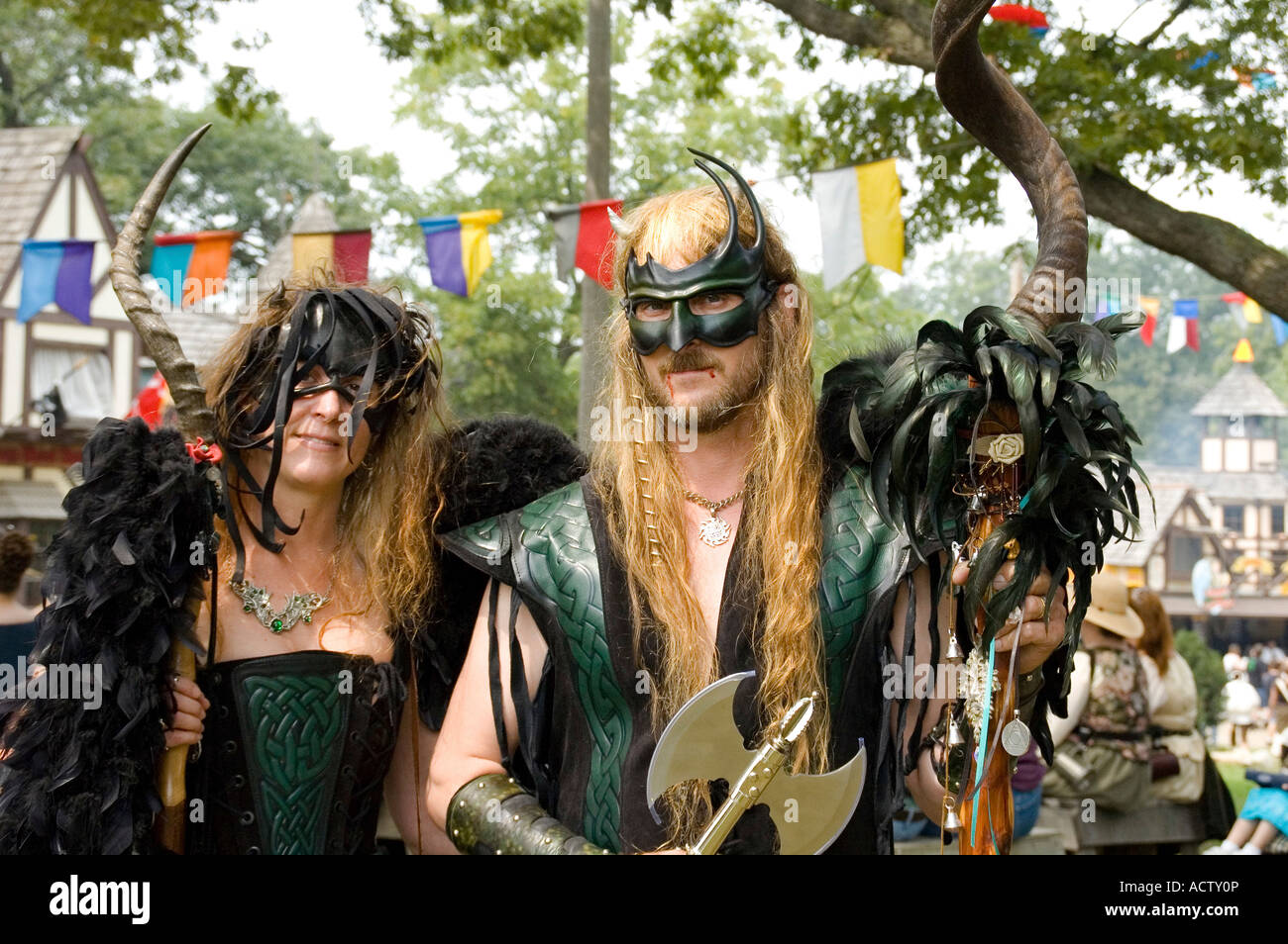 A COUPLE DRESSED IN OLD EUROPEAN CLOTHES IS POSING WITH THEIR ARMS AT RENAISSANCE FAIR IN BRISTOL, WISCONSIN Stock Photo