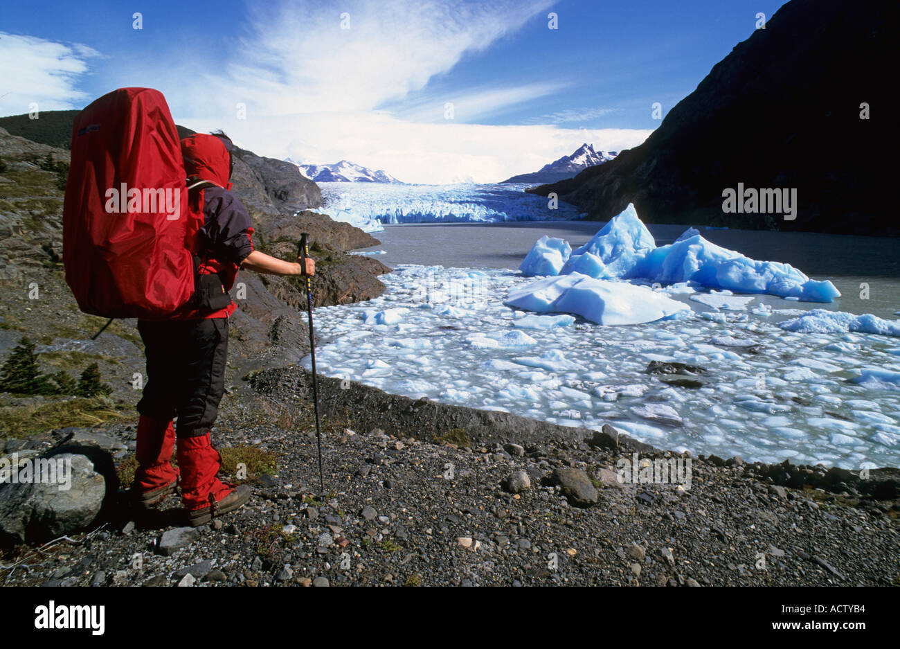 MR Woman hiking at the lake of glaciar Grey Torres del Paine national park Chile Stock Photo