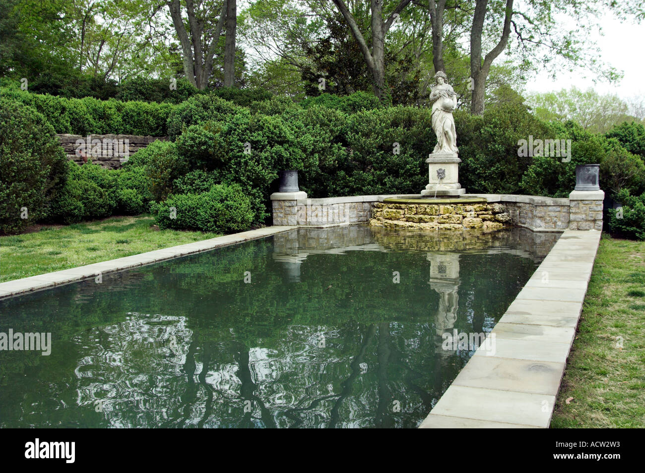A reflecting pool and sculpture in the Martin Boxwood Gardens at the