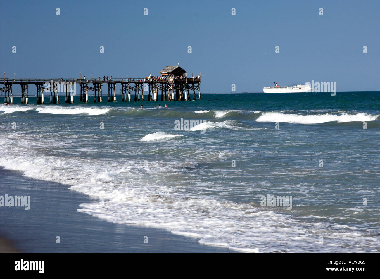 The Cocoa Beach Florida pier with cruise ship and waves Stock Photo Alamy