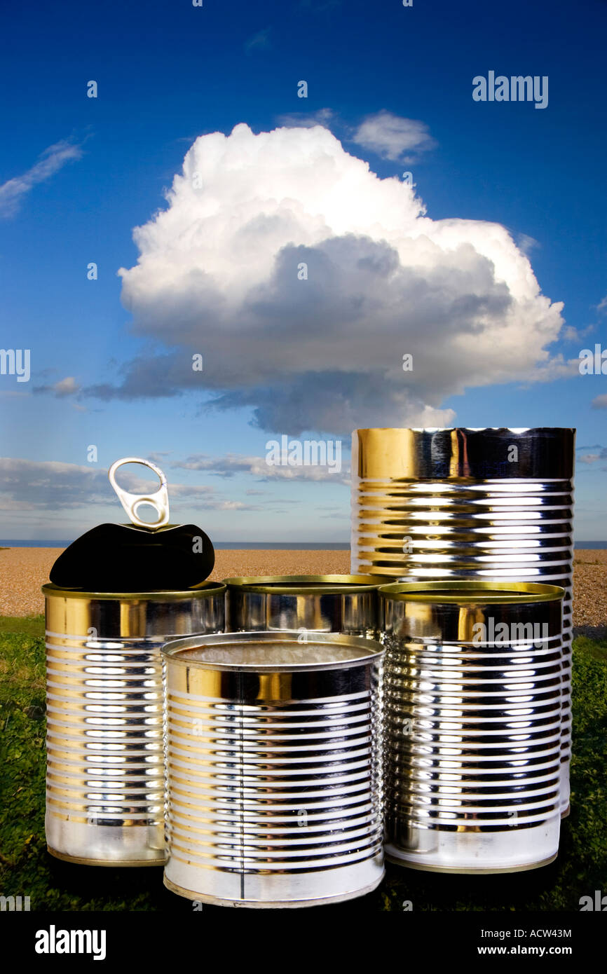 Five used tin cans against a seashore environment background Stock