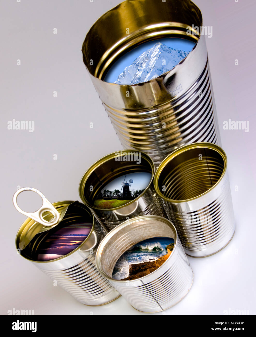 Five used tin cans containing landscape environment images Stock Photo