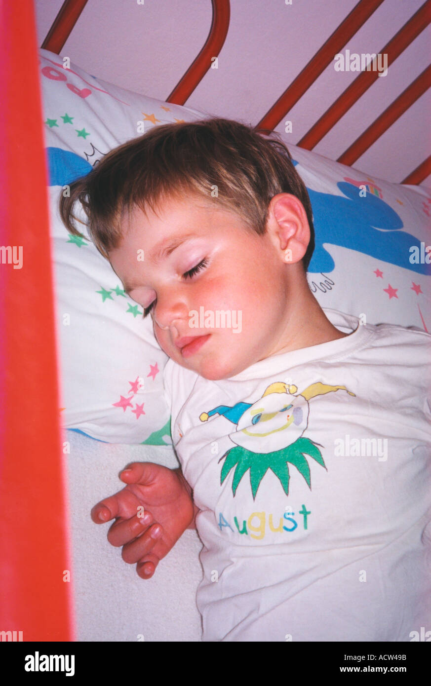 child fast asleep in bed Stock Photo