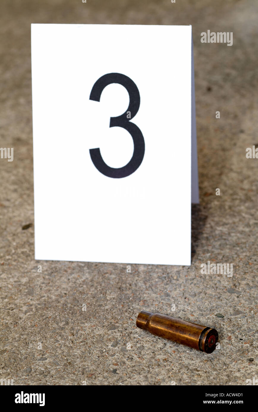 Empty Bullet Casing at a Crime Scene Marked by Forensics as Part of an Investigation Into a Violent Shooting Stock Photo