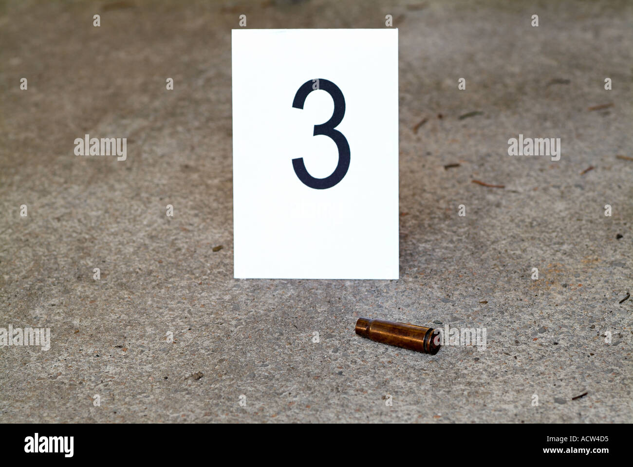 Empty Bullet Casing at a Crime Scene Marked by Forensics as Part of an Investigation Into a Violent Shooting Stock Photo