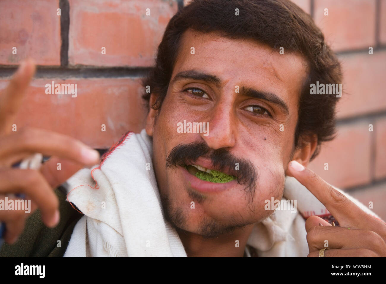 Man chewing Qat and showing the traditional bulge on his face Al Hudayda Yemen Stock Photo