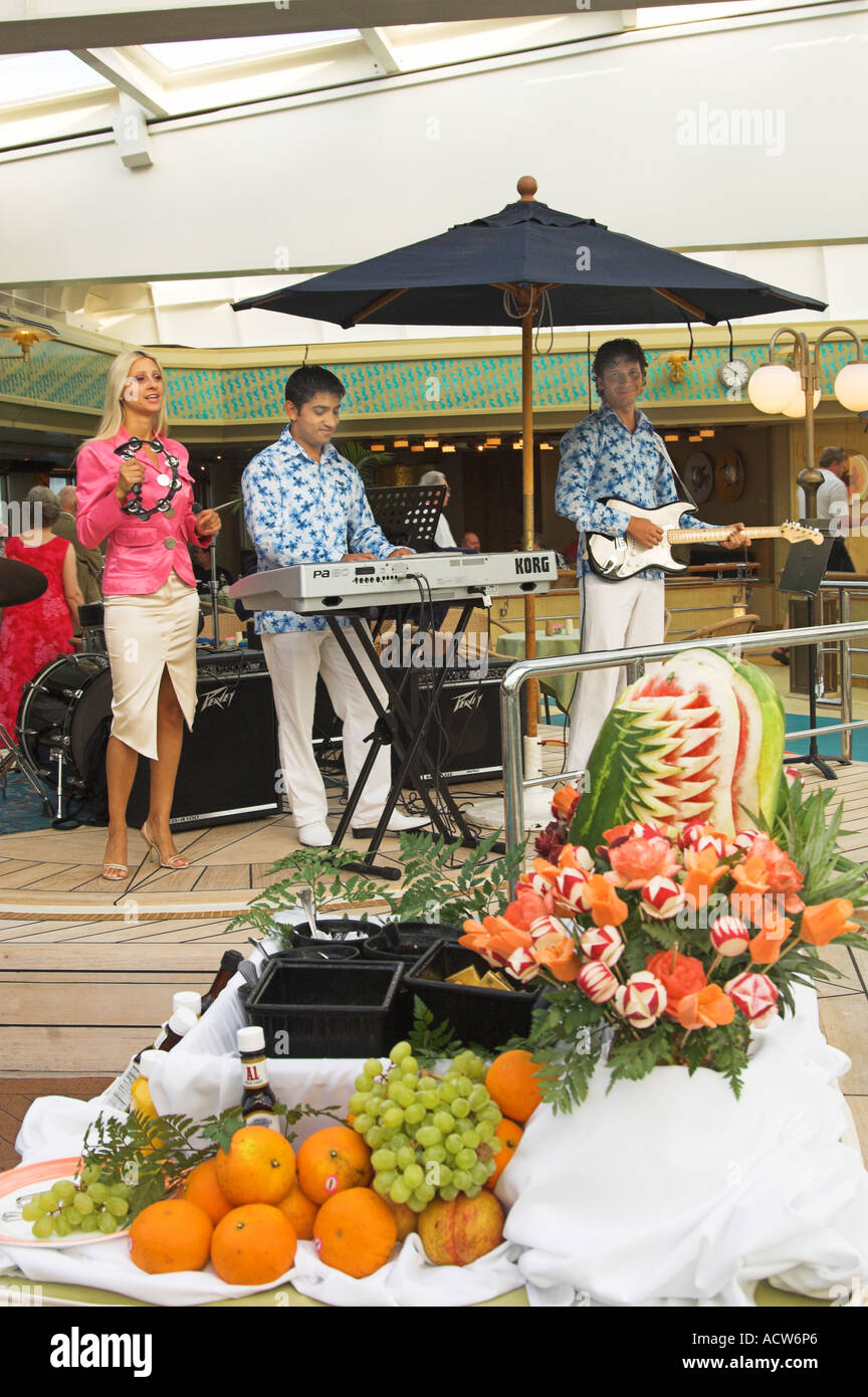 A musical entertainment group at an on deck barbeque on the Holland America cruise ship Zaandam Stock Photo