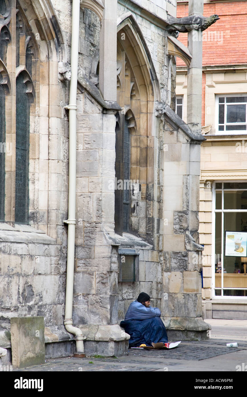 A BEGGAR SITTING OUTSIDE ST MARTIN S CHURCH IN YORK ENGLAND Stock Photo