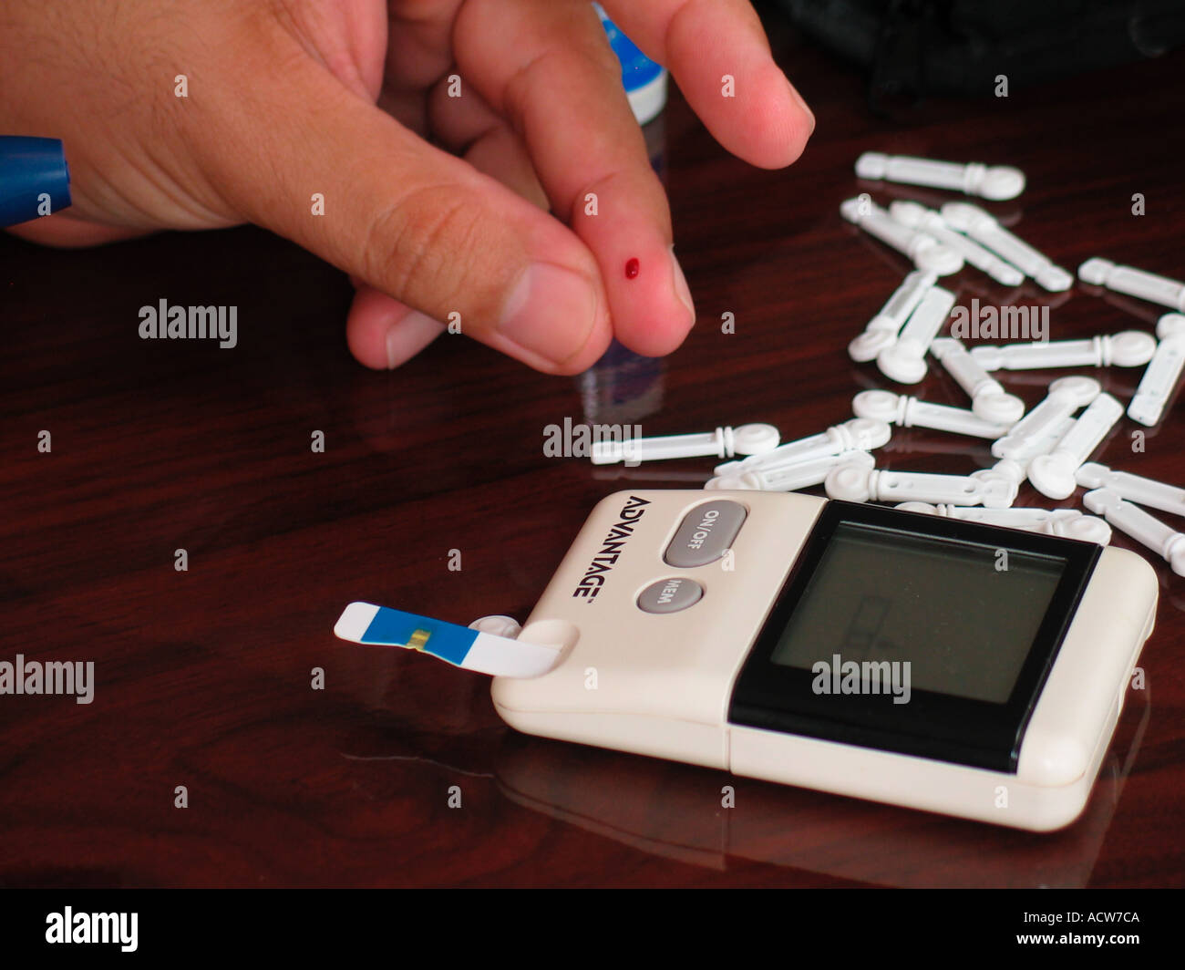 Patient extracts blood for home glucose test Stock Photo Alamy