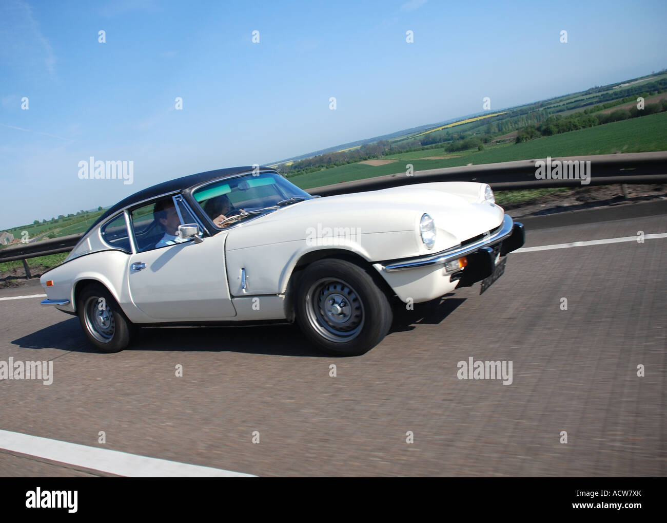 Classic British sports car - white Triumph on the road Stock Photo - Alamy