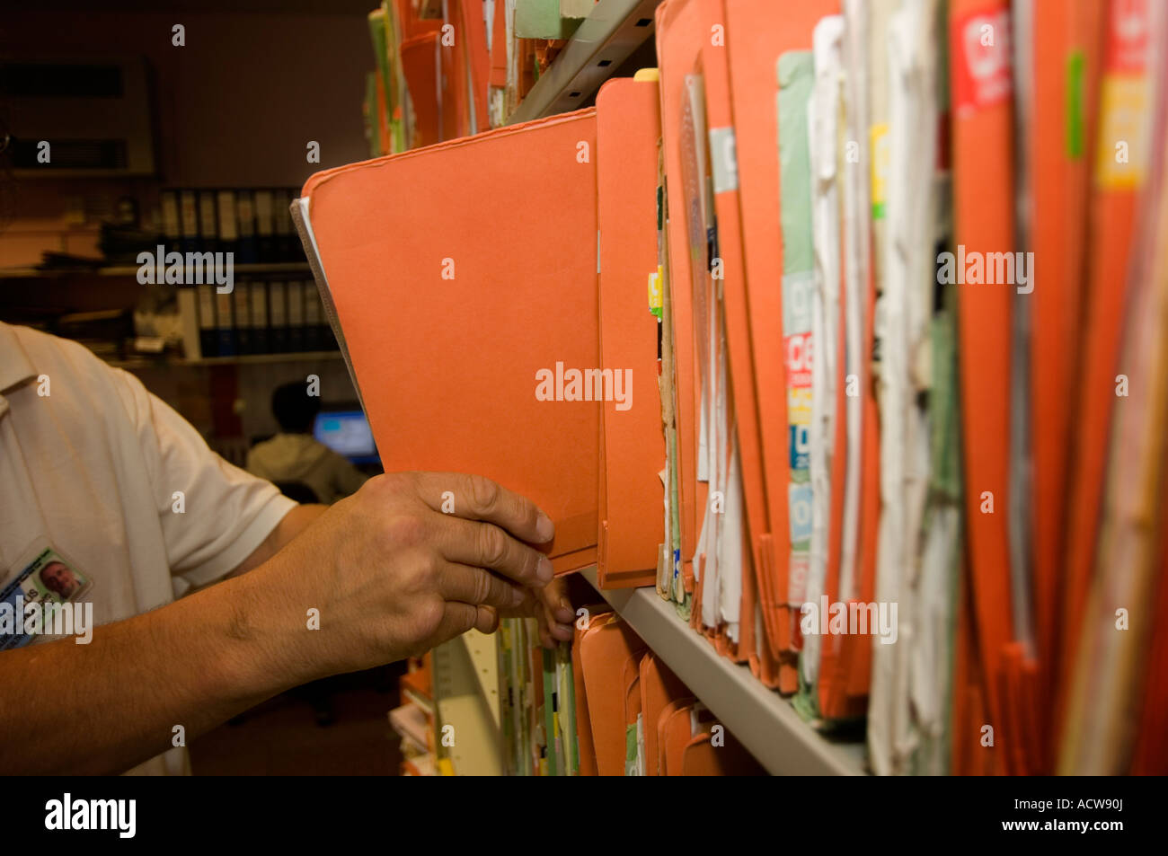 A man filing confidential patient Medical Records at a National Stock