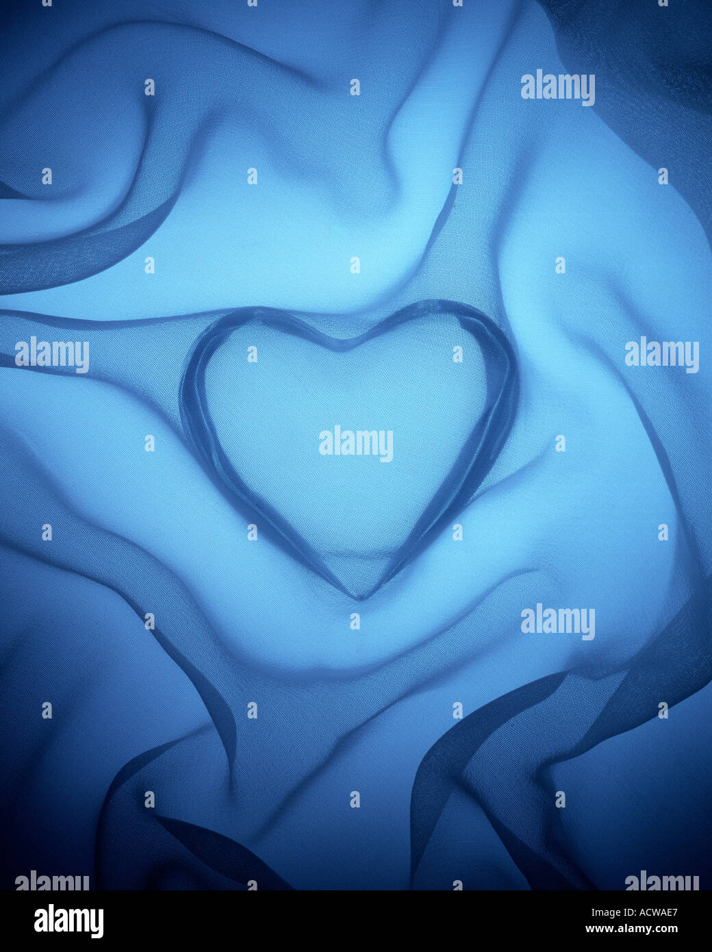 Heart covered in blue silk Stock Photo