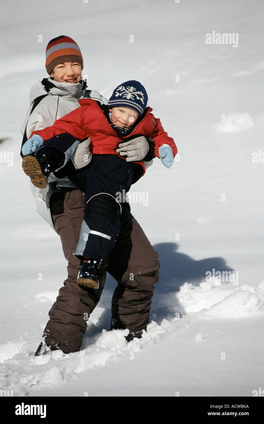 Brothers playing in snow Stock Photo - Alamy