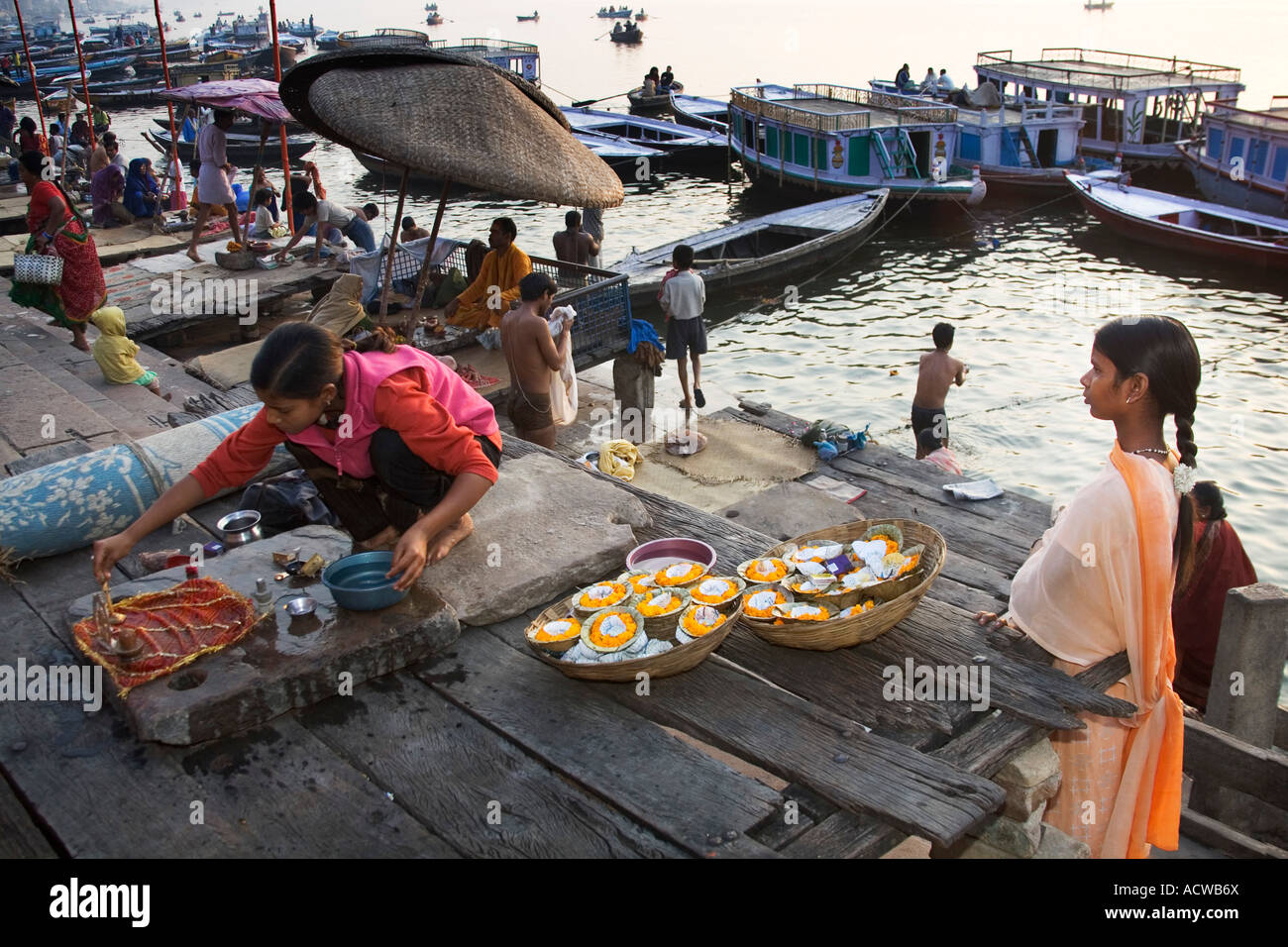 Two candle sellers prepare a small altar Varanasi Benares India Stock