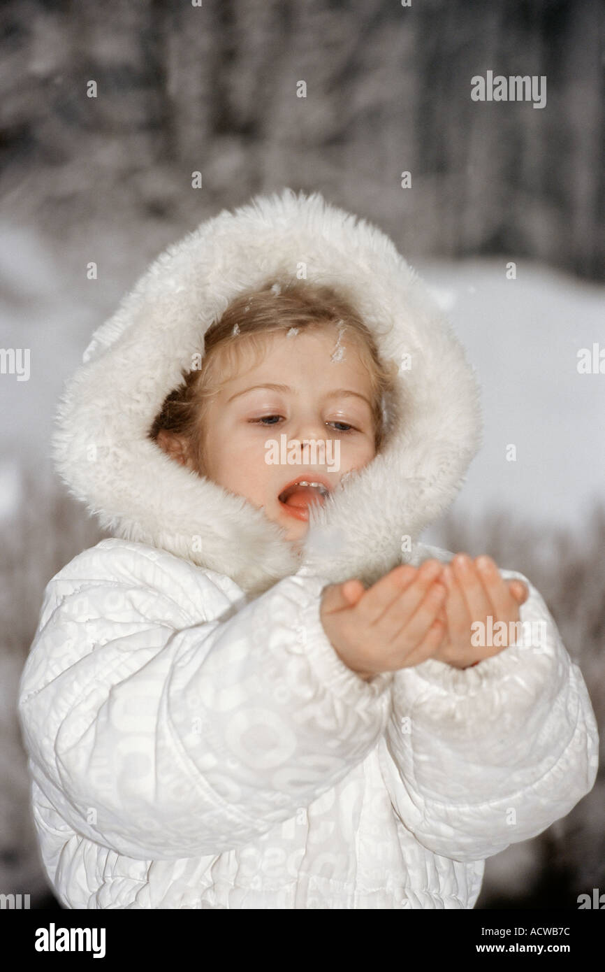 Girl catching snow in hands Stock Photo