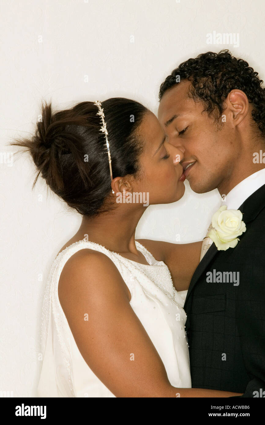 Newlywed couple kissing Stock Photo - Alamy