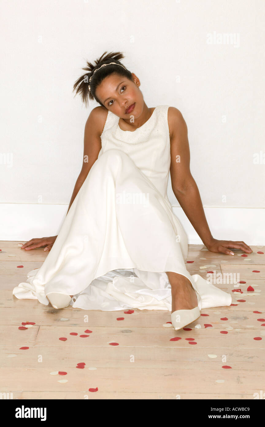 Bride sitting on wooden floor Stock Photo