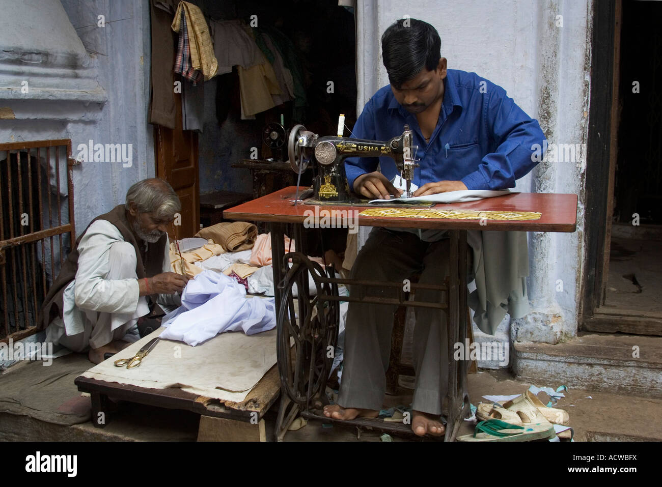 Tailor working with his old sewing machine Varanasi Benares India Stock