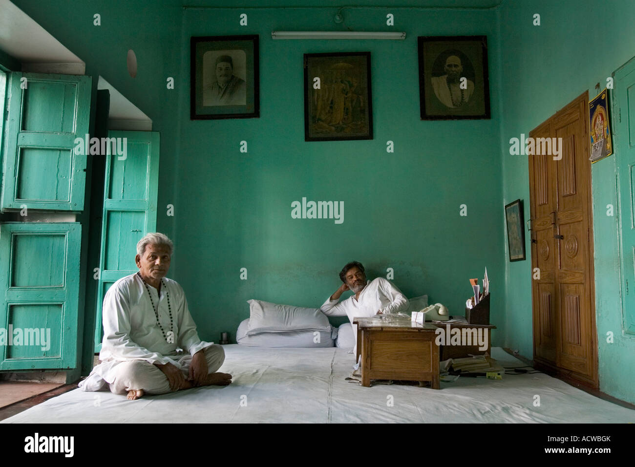 Priest in a green Tamil house Varanasi Benares India Stock Photo