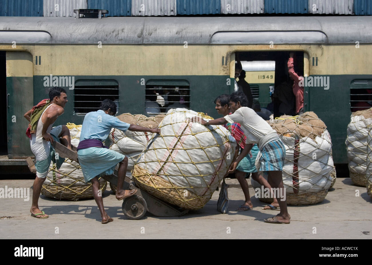 Pushing cotton bales in a railway station Calcutta Kolkata India Stock Photo