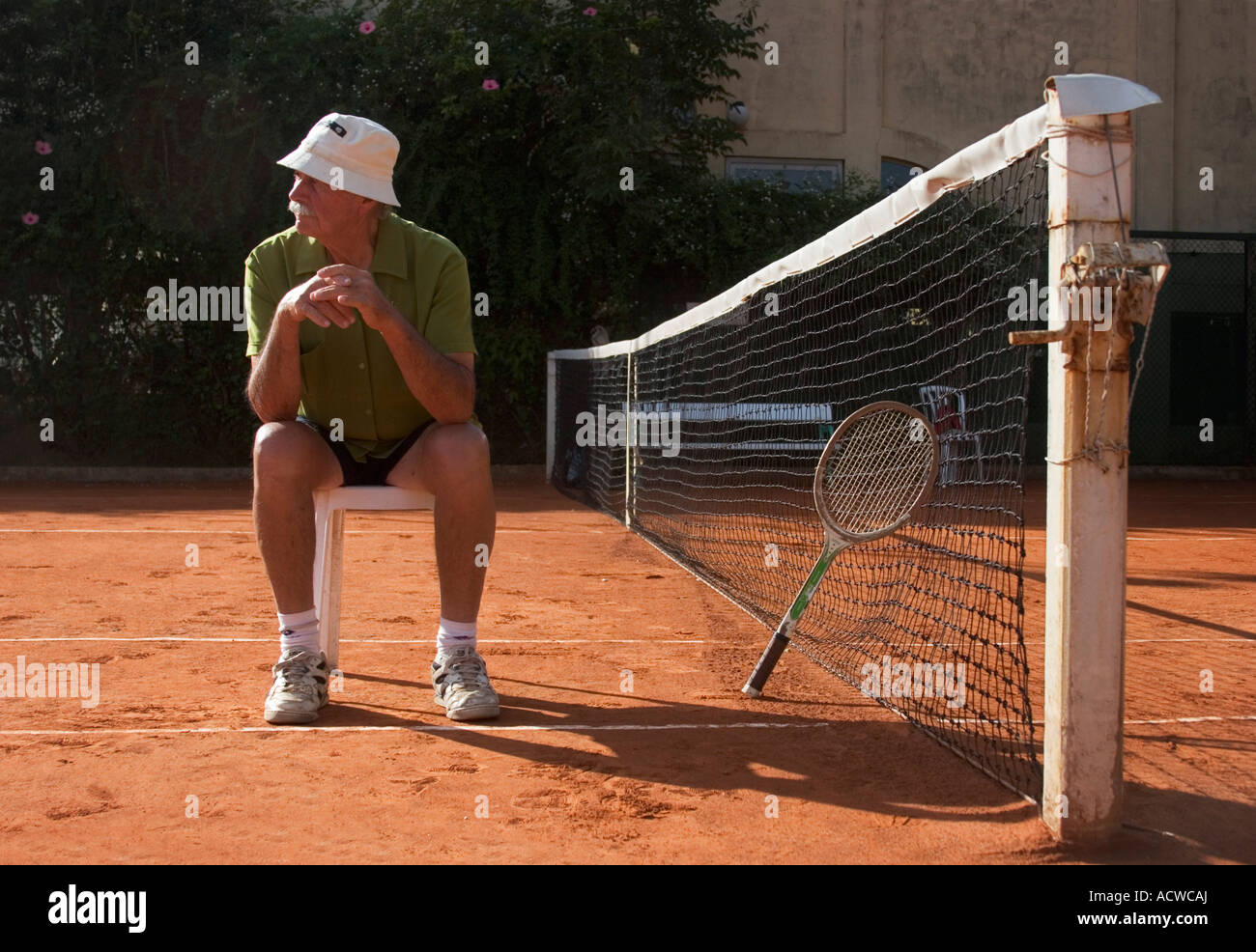 Old veteran tennis player with vintage wood racquet Stock Photo