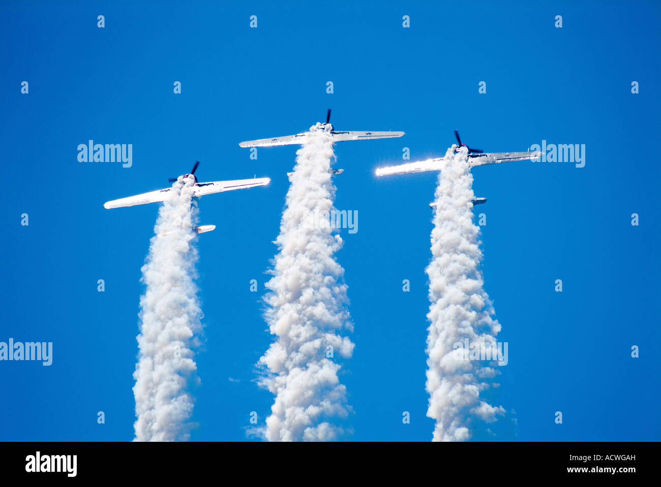 BOMBER AIR PLANES FLYING UP SIDE DOWN LEAVING HEAVY SMOKE TRAILS Stock Photo
