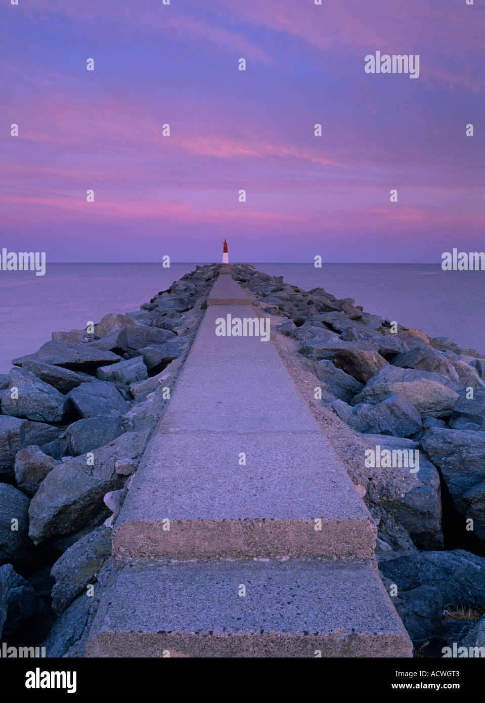 Rock and concrete Jetty/pier/breakwater at the entrance to Marina/port, EmpuriaBrava, Costa Brava, Catalonia, Spain, Europe Stock Photo