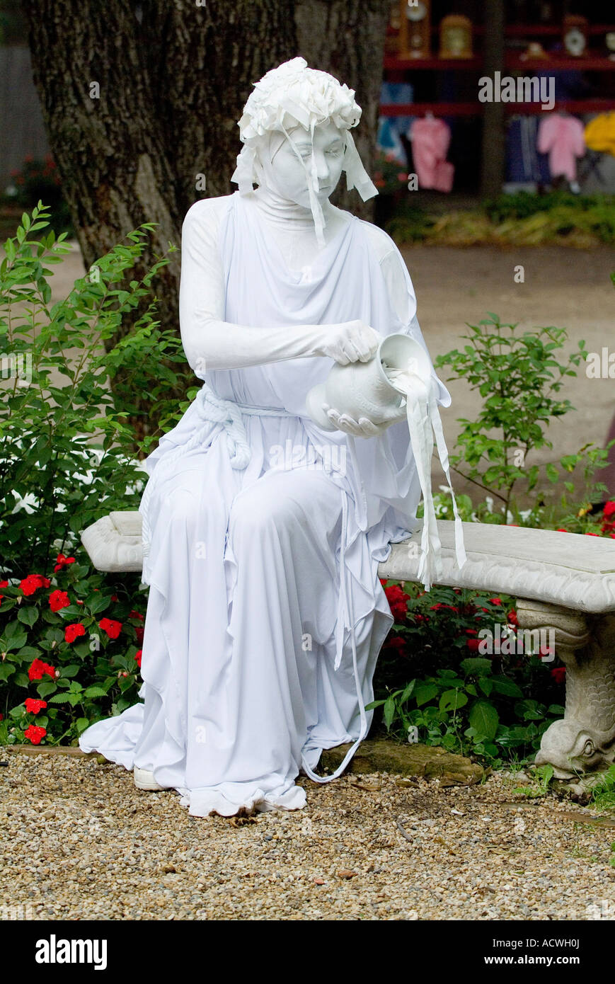 A WOMAN IS MIMING AS A WHITE MARBLE STATUE POURING WATER OUT OF A JUG Stock Photo Alamy